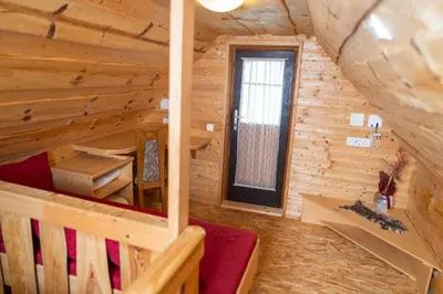 a room with a staircase in a log cabin at Apartma Metka in Bohinj