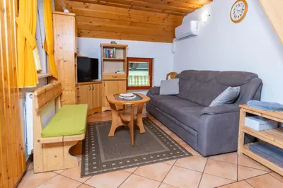 a living room with a couch and a table at Apartma Metka in Bohinj