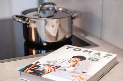 a magazine sitting on a table next to a blender at Apartma na hribu in Mojstrana