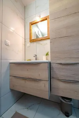a bathroom with a sink and a mirror at Apartma na hribu in Mojstrana