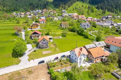 an aerial view of a small village with houses at Apartma na hribu in Mojstrana