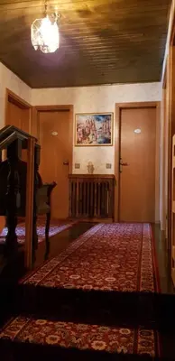 a living room with a bed and a piano at Apartma Sabatuš in Bohinj