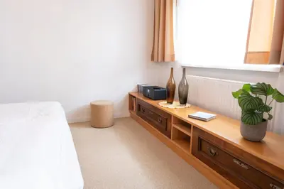 a bedroom with a bed and a table with a tv at Passero Holiday House in Moravske Toplice