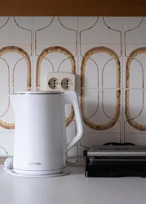 a white coffee pot sitting on top of a counter at Passero Holiday House in Moravske Toplice
