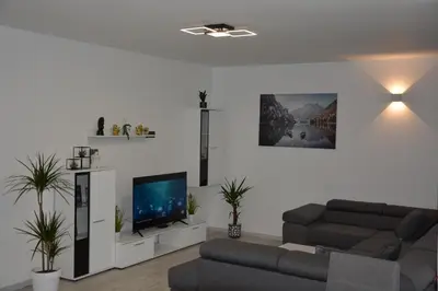 a living room with a couch and a flat screen tv at House Under The Maple Tree in Vitanje