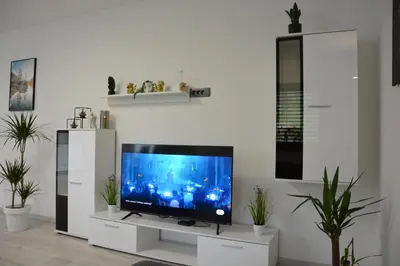 a living room with a flat screen tv on a stand at House Under The Maple Tree in Vitanje
