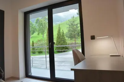 an office with a sliding glass door with a view at House Under The Maple Tree in Vitanje