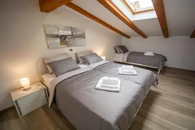 a bedroom with two beds and a skylight at Holiday house Oljka in Kobdilj