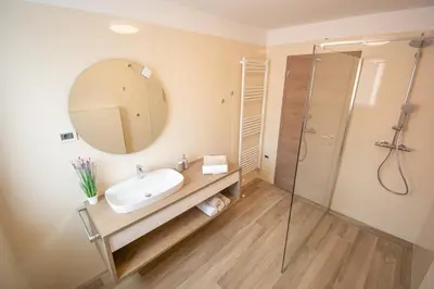 a bathroom with a sink and a mirror at Holiday house Oljka in Kobdilj