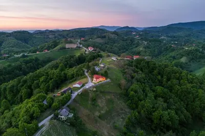 an aerial view of a forest with a train at Hill Cottage Haloze in Gruškovec