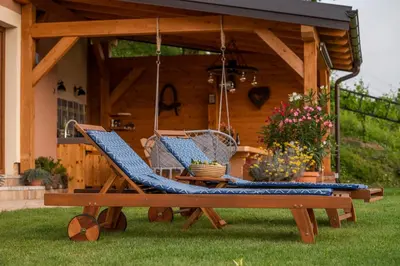 two chairs on a swing in a yard at Hill Cottage Haloze in Gruškovec