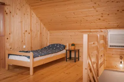 a log cabin with a bunk bed and a ladder at Apartmaji Gračner in Dramlje