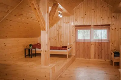 a log cabin with a bed in a room at Apartmaji Gračner in Dramlje