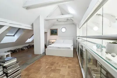 a bedroom with a bed in a loft at Matic Spacious Modern Apartment in Ljubljana