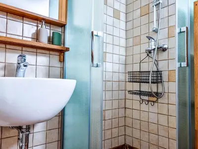 a bathroom with a sink and a shower at Jakob Cabin in Bovec