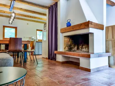 a living room with a fireplace and a table at Jakob Cabin in Bovec