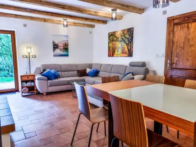a living room with a table and a couch at Jakob Cabin in Bovec