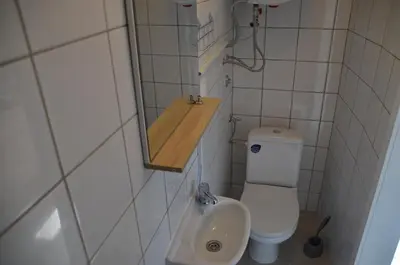 a small bathroom with a toilet and a sink at Pri stari preši in Lendava
