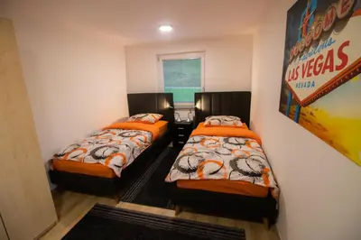 two beds in a small room with a sign on the wall at GREEN LAND Family Fun Sport Resort in Šmarje pri Jelšah