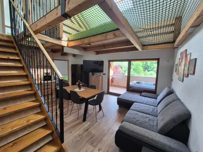 a living room with a couch and a table at GREEN LAND Family Fun Sport Resort in Šmarje pri Jelšah
