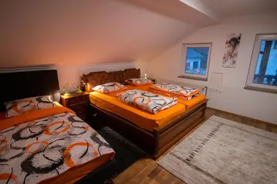 a bedroom with two beds and a window at GREEN LAND Family Fun Sport Resort in Šmarje pri Jelšah