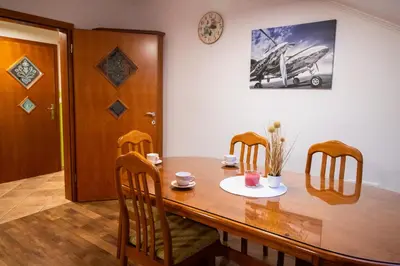 a dining room with a wooden table and chairs at GREEN LAND Family Fun Sport Resort in Šmarje pri Jelšah