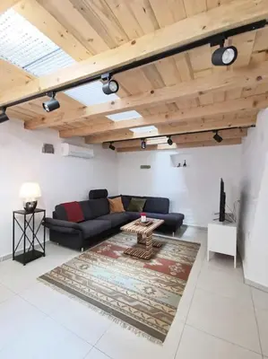a living room with a couch and a table at Smetova - The Blue Door House in Šempas