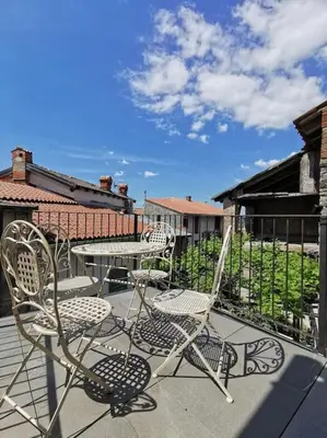 a couple of chairs and a table on a patio at Smetova - The Blue Door House in Šempas