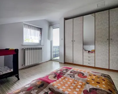 a living room with a bed and a dresser at Apartma Hilltop Haven in Šmarje pri Jelšah