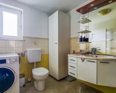 a small bathroom with a toilet and a sink at Apartma Hilltop Haven in Šmarje pri Jelšah