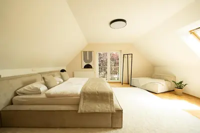 a bedroom with a large bed and a window at An der Südsteirischen Weinstraße Gamlitz - Idyllisches Ferienhäuschen im Naturparadies mit großem Whirlpool & Panoramasauna in Zgornja Kungota