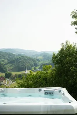 a bath tub with a view of a valley at An der Südsteirischen Weinstraße Gamlitz - Idyllisches Ferienhäuschen im Naturparadies mit großem Whirlpool & Panoramasauna in Zgornja Kungota