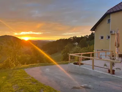 a view of a sunset from a house with a rainbow at Karla’s House in Dobje pri Planini