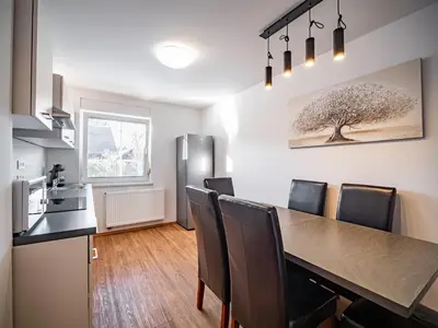 a kitchen and dining room with a table and chairs at Grand Family Residence Ljubljana in Ljubljana