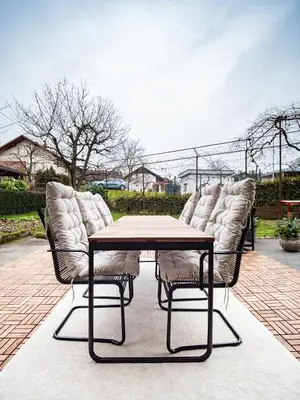 a group of chairs sitting around a table at Grand Family Residence Ljubljana in Ljubljana
