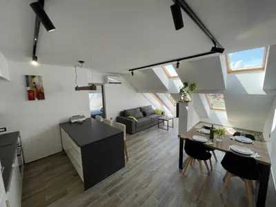 a kitchen and living room with a table and chairs at Vacation Station Ptuj in Videm pri Ptuju
