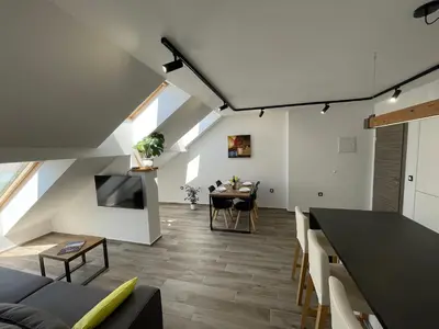 a living room with a table and a dining room at Vacation Station Ptuj in Videm pri Ptuju