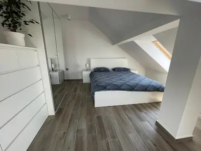 a bedroom with a bed in a attic at Vacation Station Ptuj in Videm pri Ptuju
