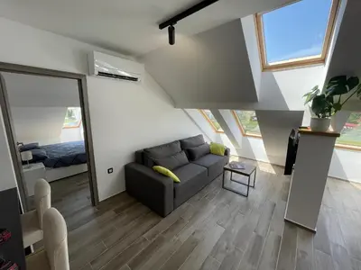 a living room with a couch and a bedroom at Vacation Station Ptuj in Videm pri Ptuju