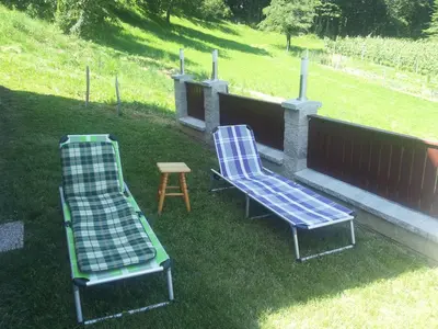 two chairs and a table in the grass at Holiday Home Češnovar in Raka