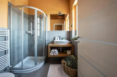 a bathroom with a shower and a sink at Klinec Plešivo Art Rooms in Dobrovo