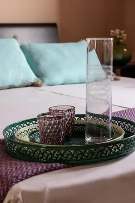 a tray with a glass on top of a table at Klinec Plešivo Art Rooms in Dobrovo