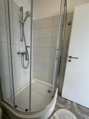 a shower with a glass door in a bathroom at OM Yoga center in Slovenska Bistrica