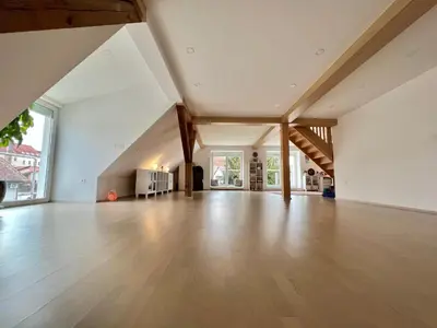 an empty living room with wooden floors and ceilings at OM Yoga center in Slovenska Bistrica