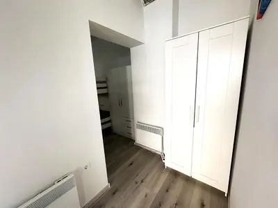 an empty room with white walls and wooden floors at OM Yoga center in Slovenska Bistrica