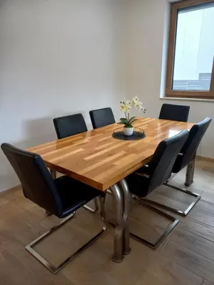 a dining room table with black chairs around it at Duplex Holiday Apartment in Škofljica