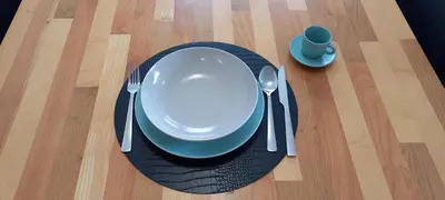 a plate and fork and a cup on a table at Duplex Holiday Apartment in Škofljica