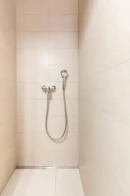 a shower with a shower head on a wall at Duplex Holiday Apartment in Škofljica