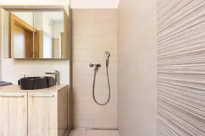 a bathroom with a shower and a sink at Duplex Holiday Apartment in Škofljica