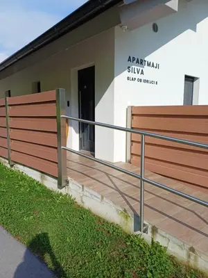a house with a wooden deck in front of it at APARTMAJI SILVA in Slappe dʼIdria